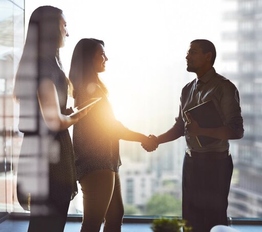 Lets move business forward together. Cropped shot of businesspeople shaking hands in an office.